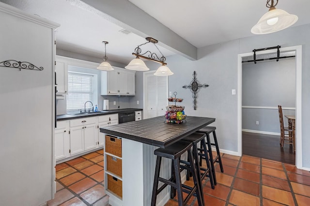 1302 E Franklin St, Hillsboro, TX 76645 - kitchen with hanging light fixtures, a kitchen breakfast bar, and white cabinets