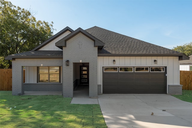 view of front of home featuring a garage and a front lawn