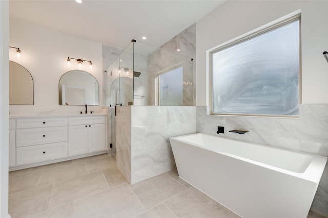 bathroom featuring vanity, tile patterned flooring, separate shower and tub, and tile walls