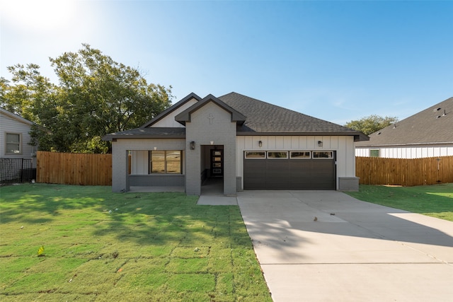 view of front of property with a garage and a front yard