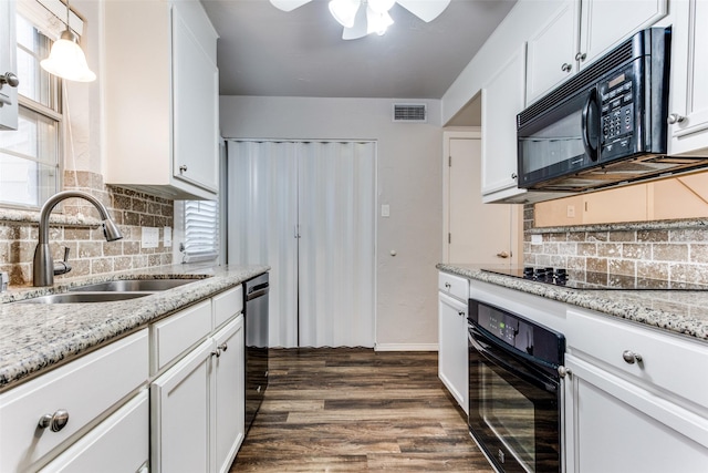 kitchen with sink, white cabinetry, decorative light fixtures, dark hardwood / wood-style flooring, and black appliances