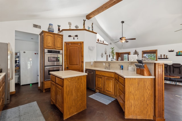 kitchen featuring ceiling fan, stainless steel appliances, beamed ceiling, kitchen peninsula, and a kitchen island