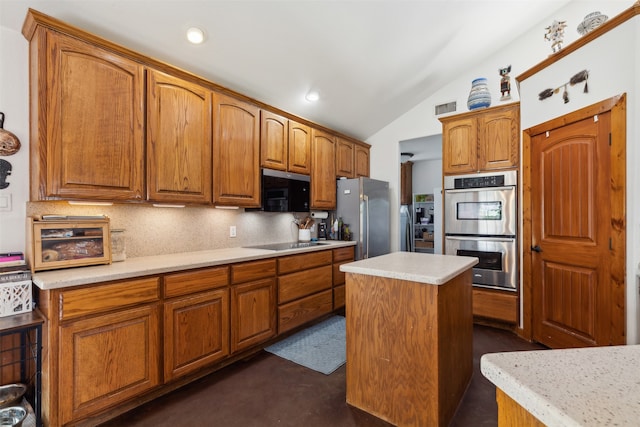 kitchen featuring a kitchen island, lofted ceiling, backsplash, and appliances with stainless steel finishes