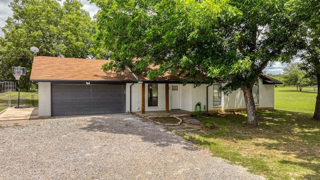 single story home featuring a garage and a front lawn