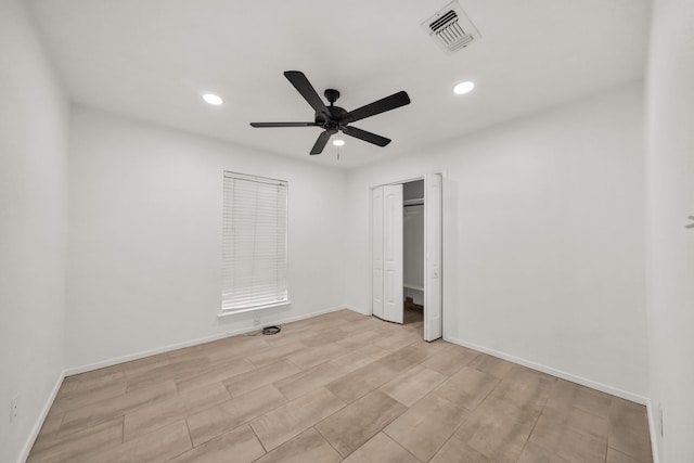 unfurnished bedroom with ceiling fan and a closet