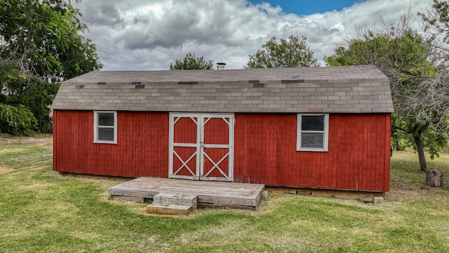 view of outdoor structure with a lawn