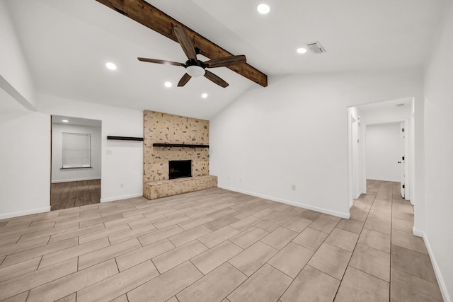 unfurnished living room featuring a fireplace, vaulted ceiling with beams, and ceiling fan