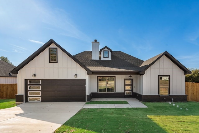 modern farmhouse featuring a garage and a front yard