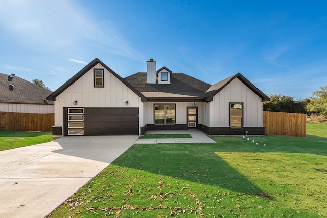 modern farmhouse style home featuring a front lawn and a garage