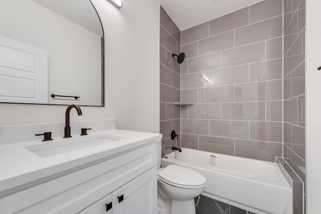 full bathroom featuring tiled shower / bath, toilet, and vanity