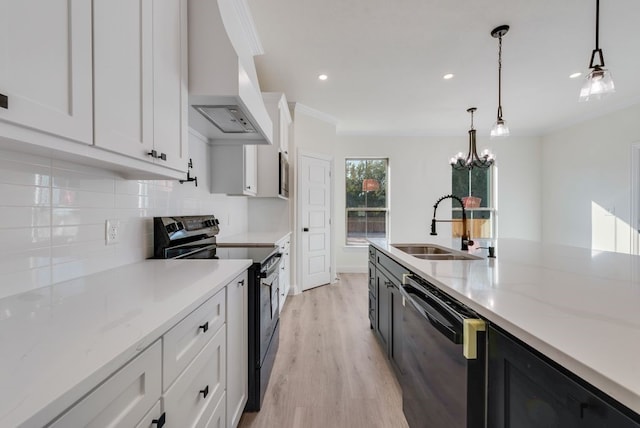 kitchen featuring stainless steel electric range oven, pendant lighting, custom range hood, and black dishwasher