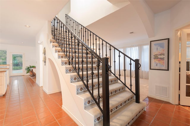 stairs featuring tile patterned flooring