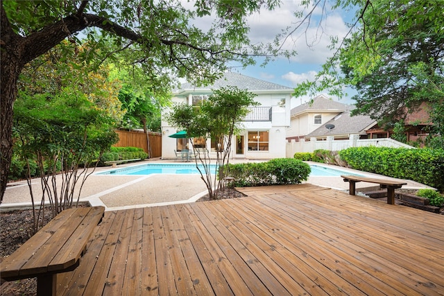 view of pool featuring a wooden deck and a patio