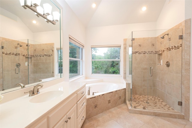 bathroom with plus walk in shower, vanity, tile patterned flooring, and vaulted ceiling