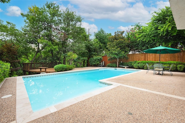 view of pool with a patio and a wooden deck