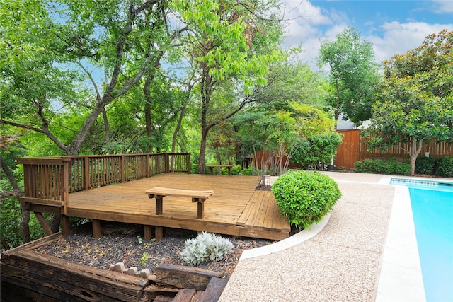 wooden terrace featuring a fenced in pool