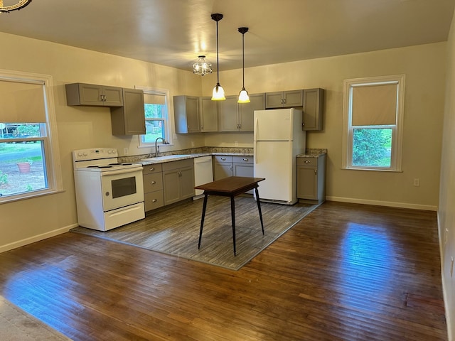 kitchen featuring dark hardwood / wood-style flooring, gray cabinetry, white appliances, sink, and decorative light fixtures