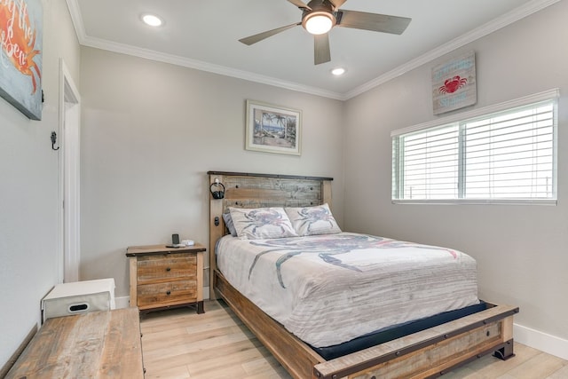 bedroom featuring ceiling fan, light wood-type flooring, and multiple windows