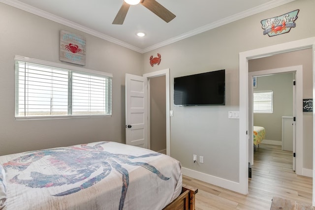 bedroom with ceiling fan, light hardwood / wood-style floors, and multiple windows