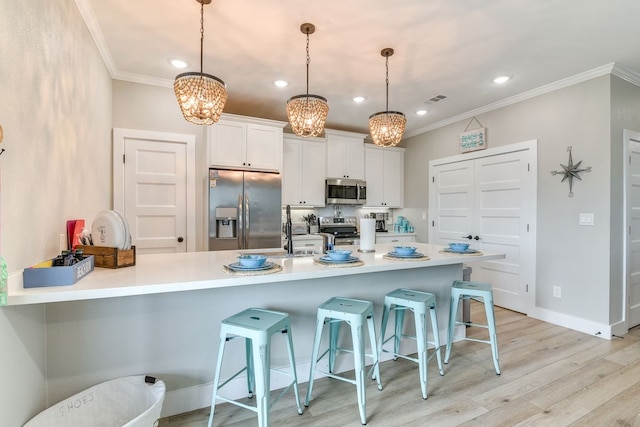 kitchen with light hardwood / wood-style flooring, stainless steel appliances, backsplash, white cabinetry, and ornamental molding