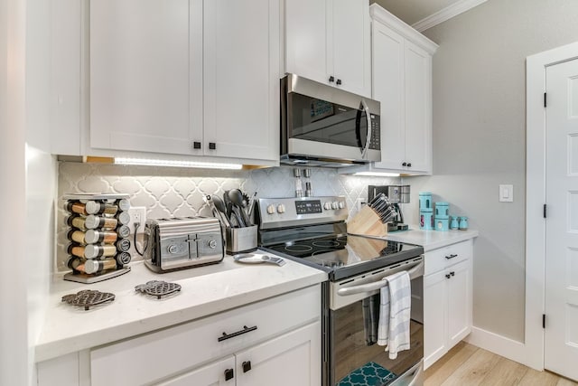 kitchen with light hardwood / wood-style floors, ceiling fan with notable chandelier, white cabinetry, sink, and pendant lighting