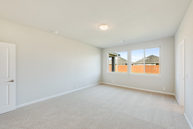 unfurnished room featuring light colored carpet