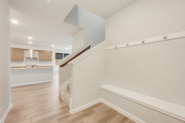 stairway with hardwood / wood-style flooring