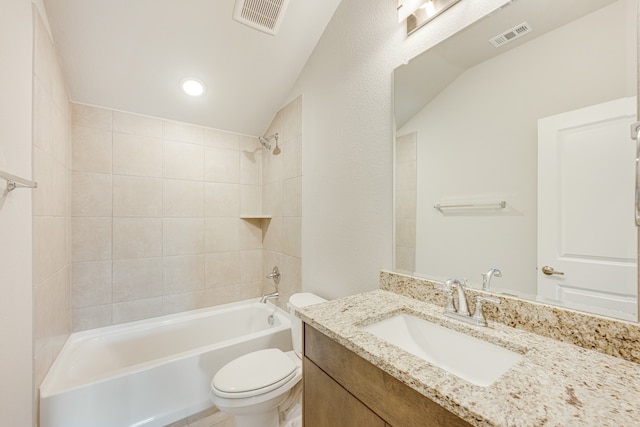 full bathroom with vanity, toilet, vaulted ceiling, and tiled shower / bath combo