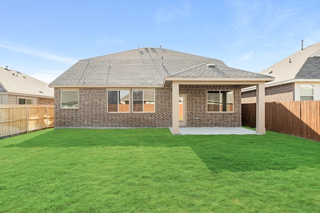 back of property featuring a patio area and a lawn