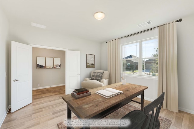 home office with light hardwood / wood-style floors