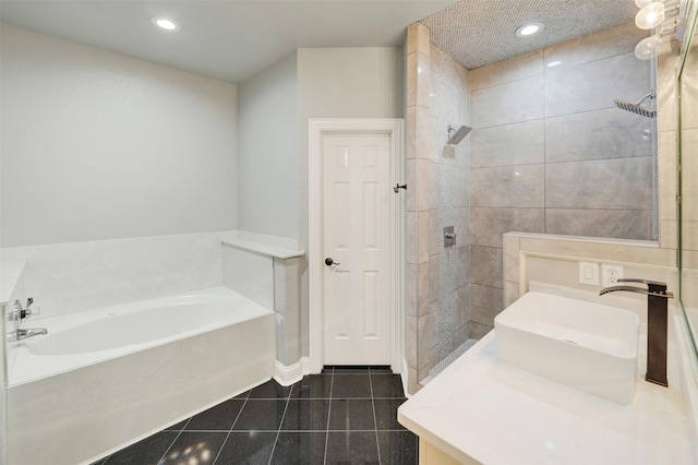 bathroom with plus walk in shower, vanity, and tile patterned floors