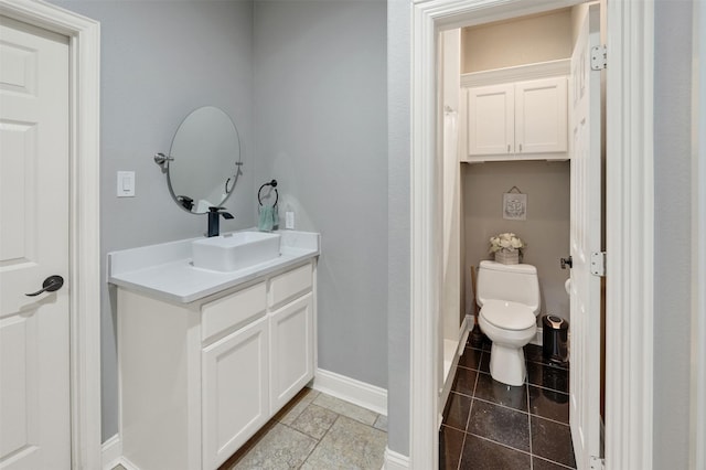 bathroom with tile patterned flooring, vanity, and toilet