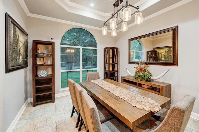 dining room with ornamental molding and a chandelier