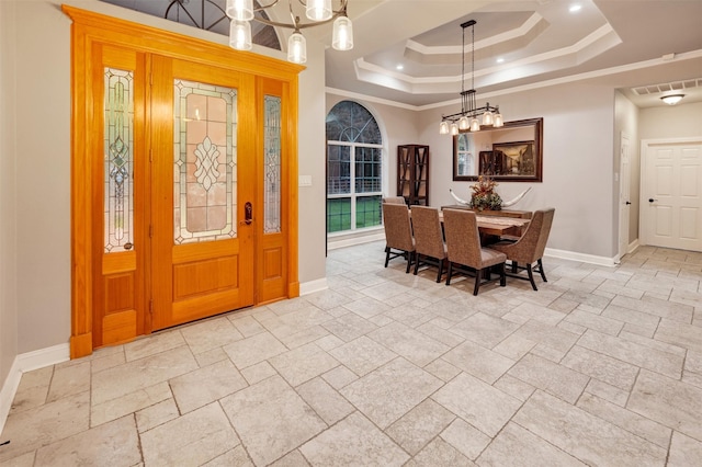 dining room with a raised ceiling and crown molding