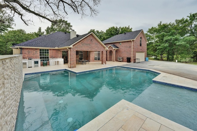 view of swimming pool with a patio and area for grilling