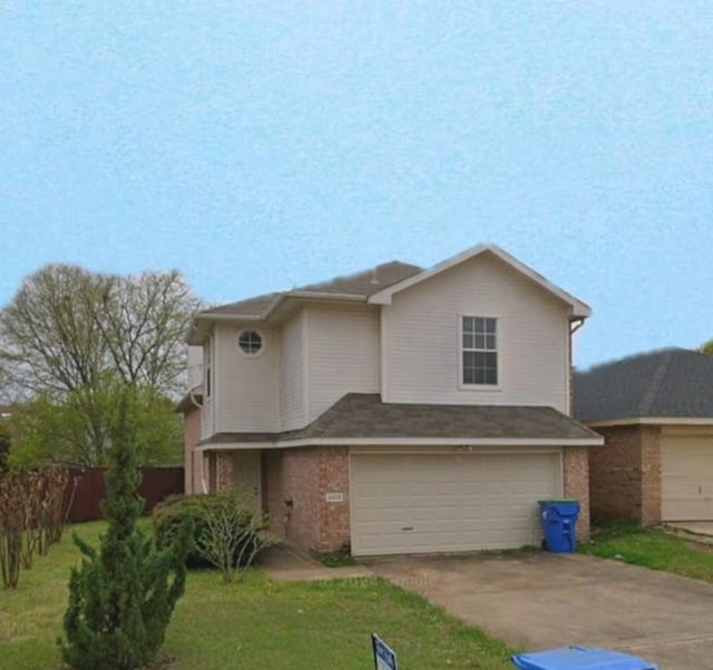 view of front property featuring a garage and a front lawn