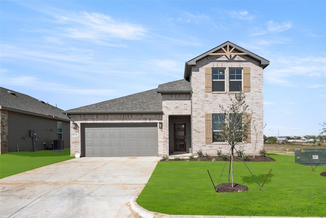 view of front of home featuring central AC unit, a garage, and a front yard