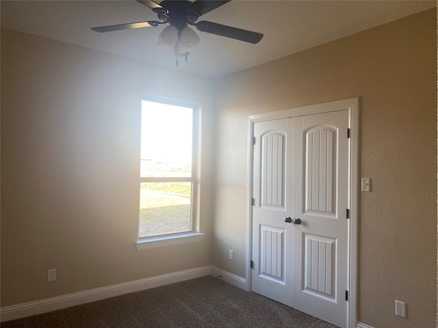 unfurnished bedroom with a closet, ceiling fan, and carpet floors