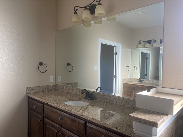 bathroom featuring vanity with extensive cabinet space