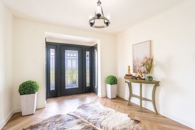 entryway featuring light parquet floors and a chandelier