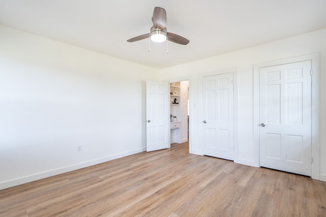 unfurnished bedroom with ceiling fan and light wood-type flooring