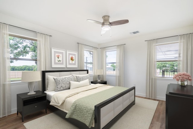 bedroom with ceiling fan and wood-type flooring