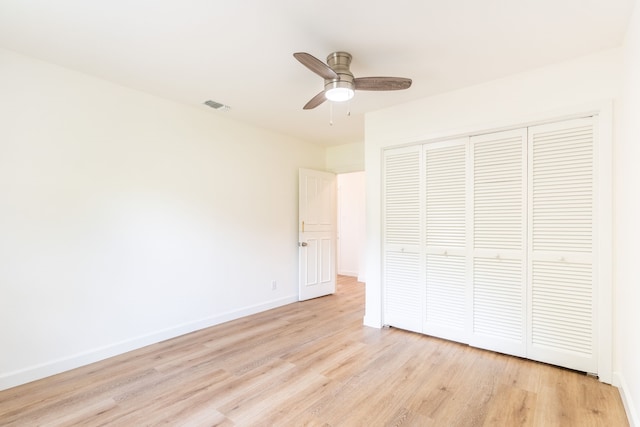 unfurnished bedroom featuring ceiling fan, a closet, and light hardwood / wood-style flooring