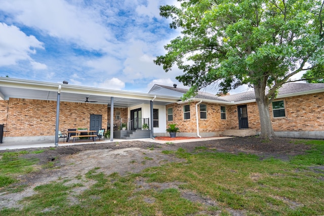 rear view of property featuring covered porch