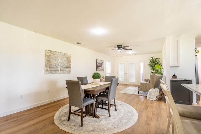 dining space featuring ceiling fan, light hardwood / wood-style flooring, and french doors