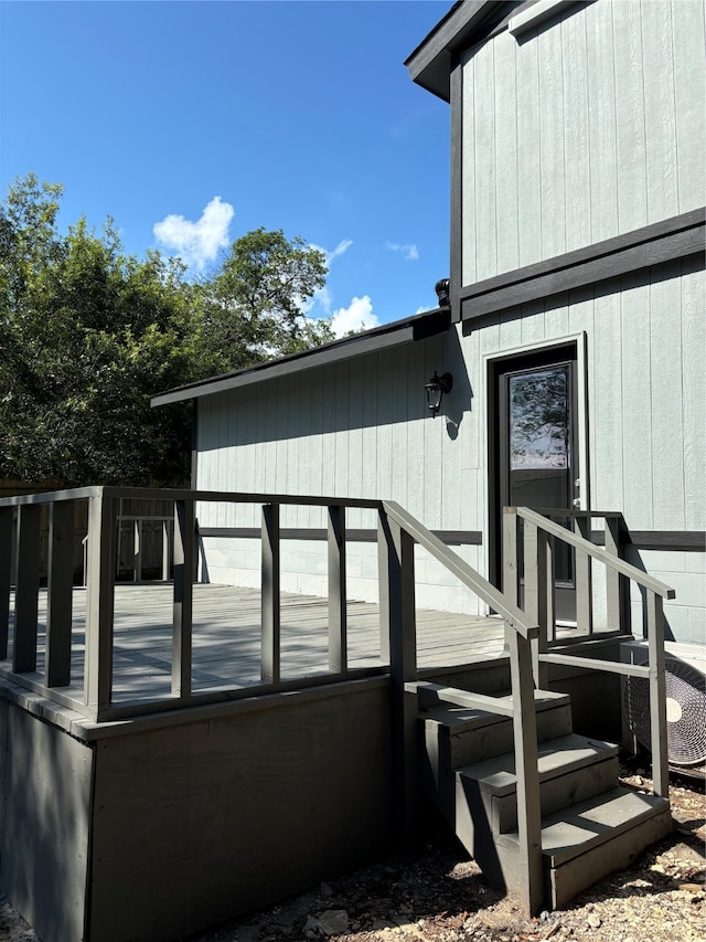 view of exterior entry with a deck