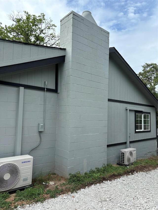 view of side of home with central AC