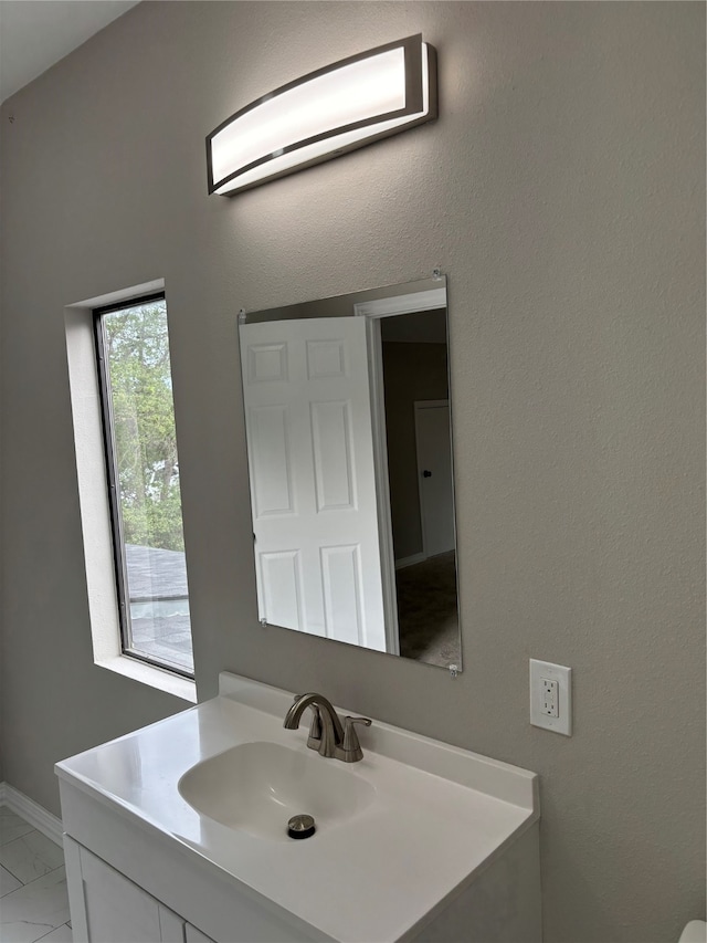 bathroom with tile floors, vanity, and an AC wall unit