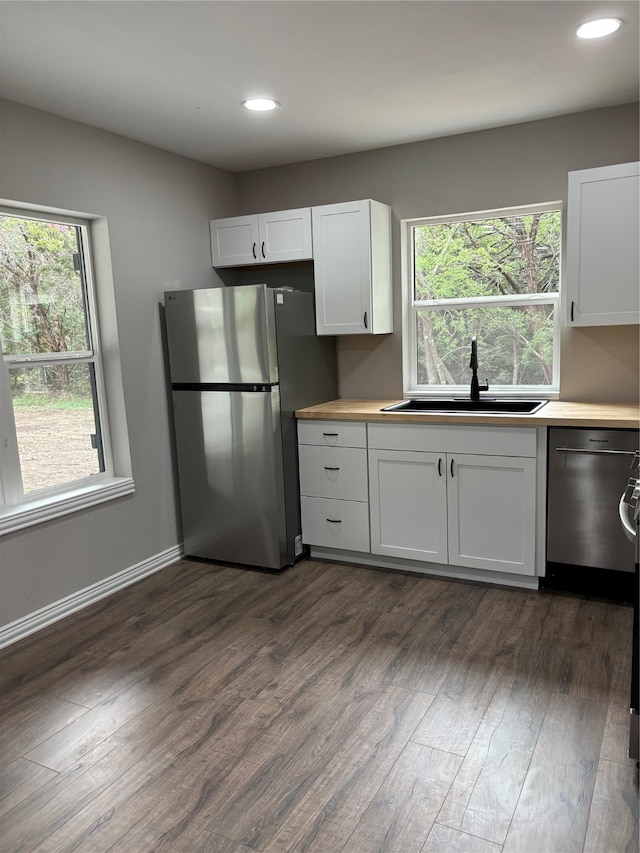 kitchen with stainless steel appliances, dark hardwood / wood-style flooring, a healthy amount of sunlight, and sink