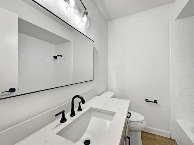 full bathroom with vanity, toilet, bathtub / shower combination, and hardwood / wood-style floors